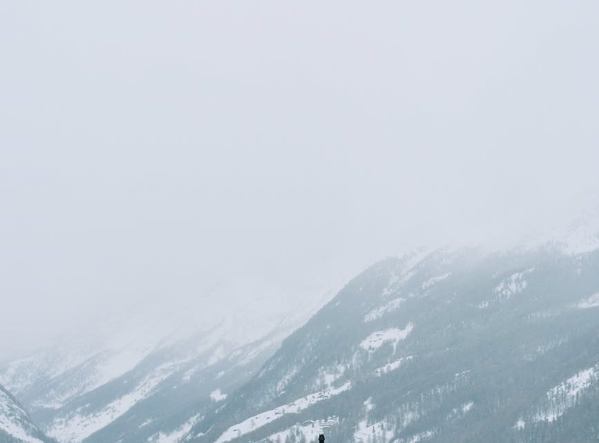 lonely wooden house on mountain among snow